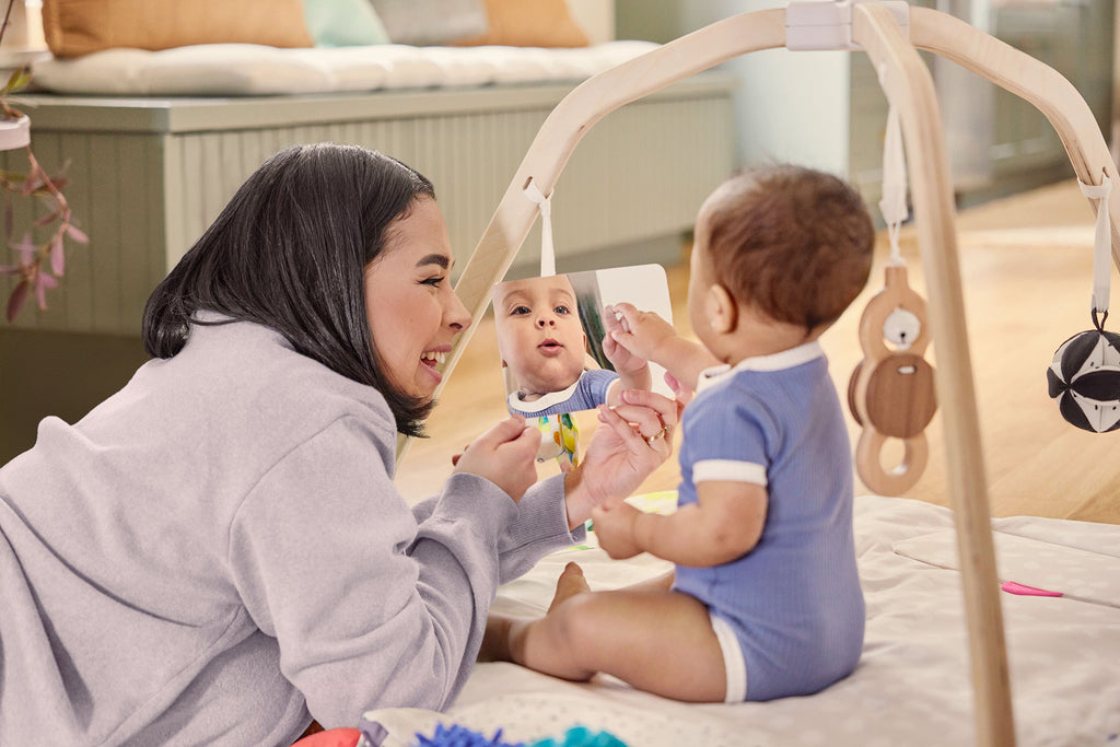 Woman playing with a baby on a lovevery play gym