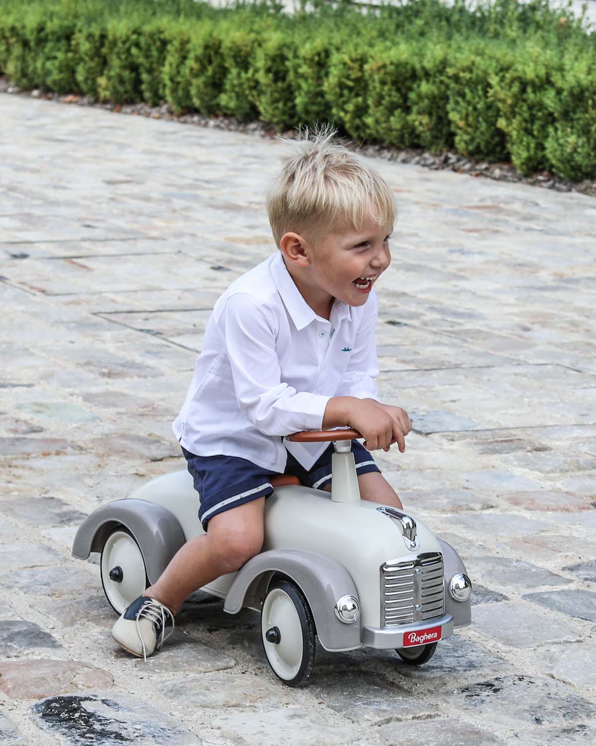 Cream  vintage style baghera ride-on speedster on a white background
