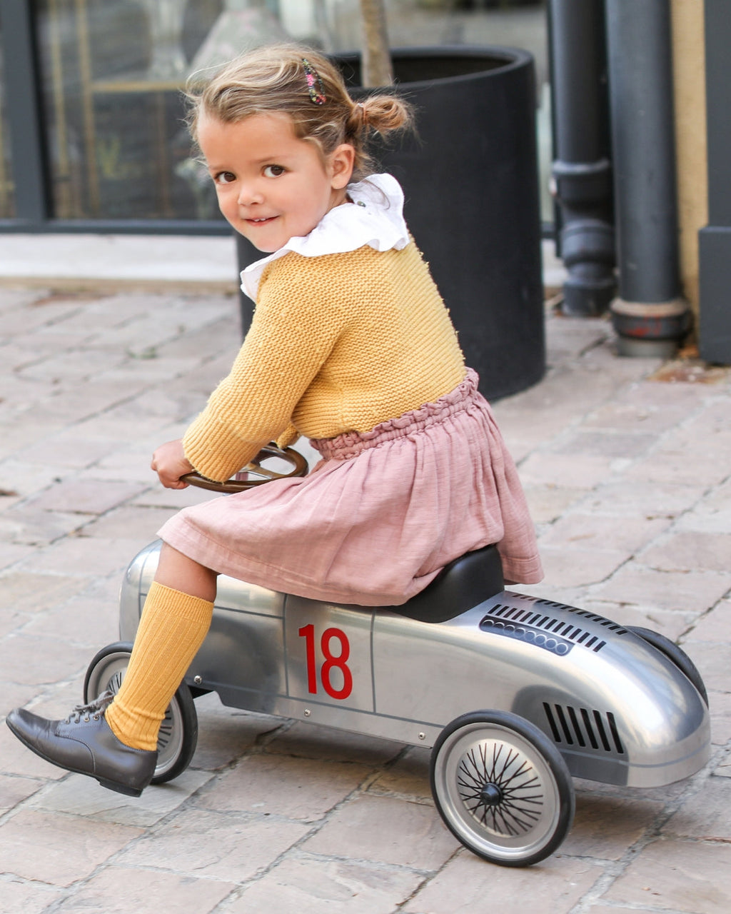 Silver vintage style baghera ride-on roadster with the number 18 on a white background