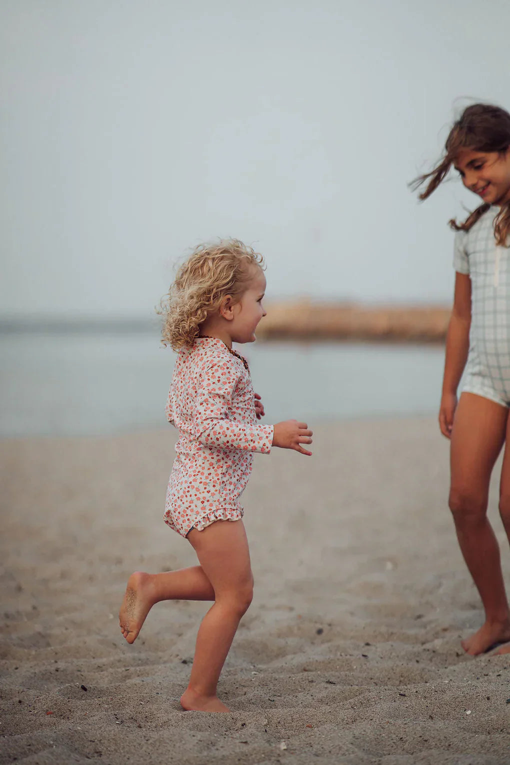GRECH & CO. Long Sleeve Rashguard Ruffle Swimsuit | UPF + Recycled - Sunset Meadow | Playroom Avenue