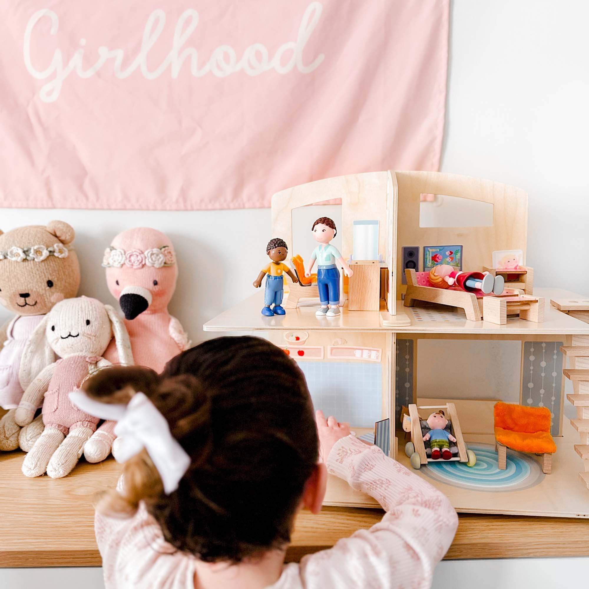 Child playing with HABA Little Friends Dollhouse Town Villa with Furniture - Complete Dollhouse | HABA USA