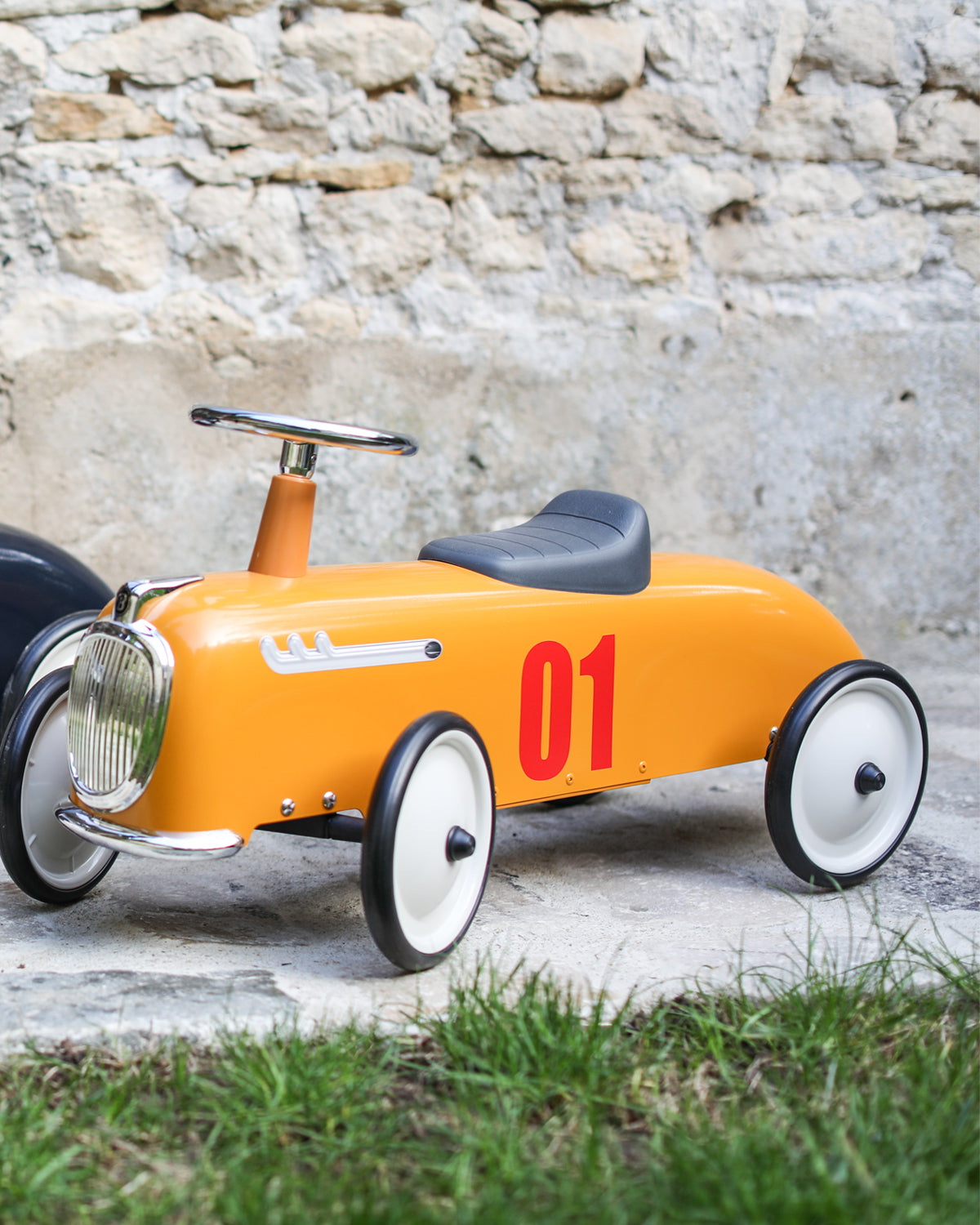 Yellow baghera ride-on roadster with the number 01 on a white background
