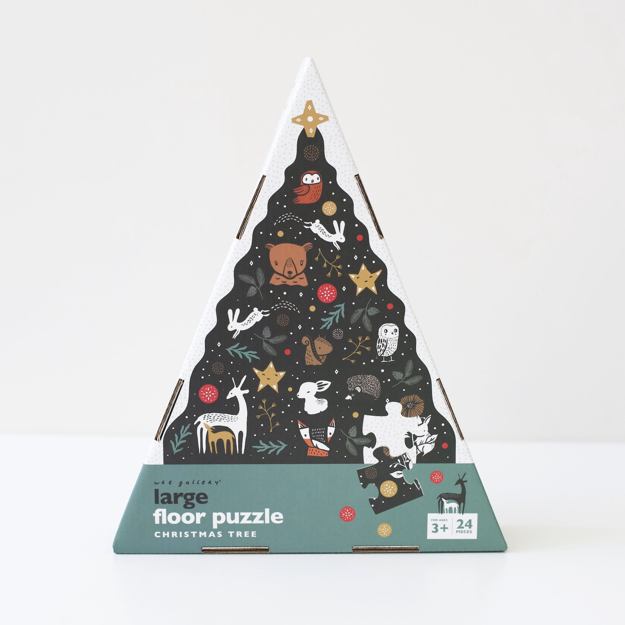 Christmas tree-shaped floor puzzle packaging with illustrations on a white background