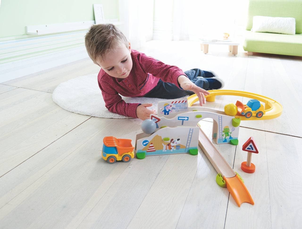 Child playing with HABA Kullerbu Construction Site Track Starter Set - Themed Ball Track | HABA USA