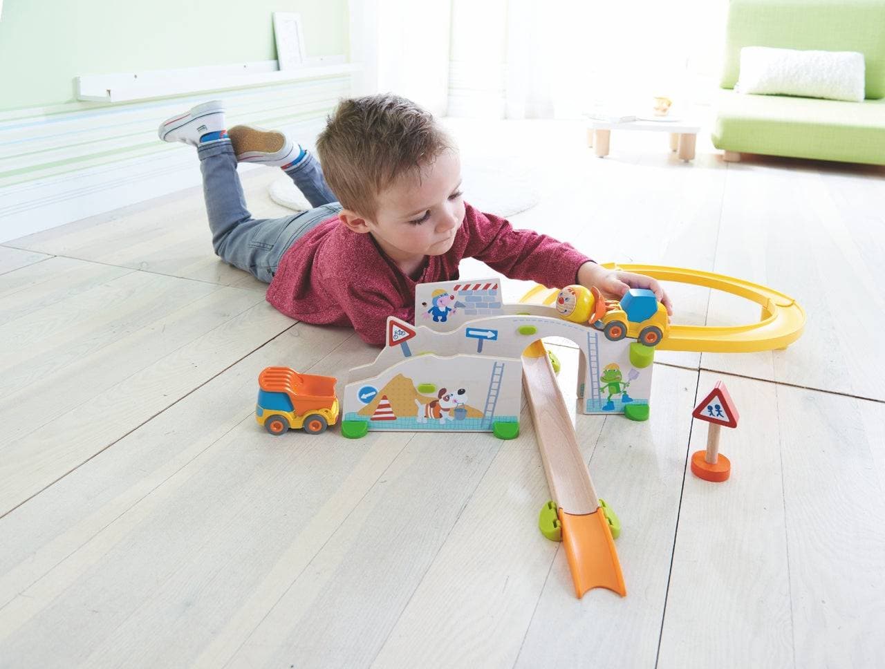 child playing with HABA Kullerbu Construction Site Track Starter Set - Themed Ball Track | HABA USA
